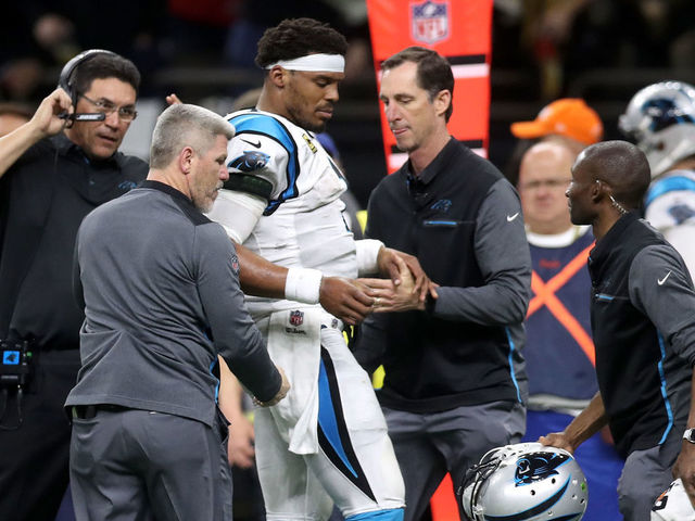 NEW ORLEANS, LA - JANUARY 07: Cam Newton #1 of the Carolina Panthers is checked on the sideline after a tackle during the game against the New Orleans Saints at the Mercedes-Benz Superdome on January 7, 2018 in New Orleans, Louisiana.