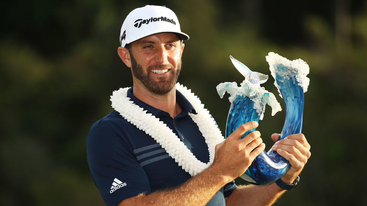 LAHAINA, HI - JANUARY 07: Dustin Johnson of the United States celebrates with the winner's trophy after winning during the final round of the Sentry Tournament of Champions at Plantation Course at Kapalua Golf Club on January 7, 2018 in Lahaina, Hawaii.