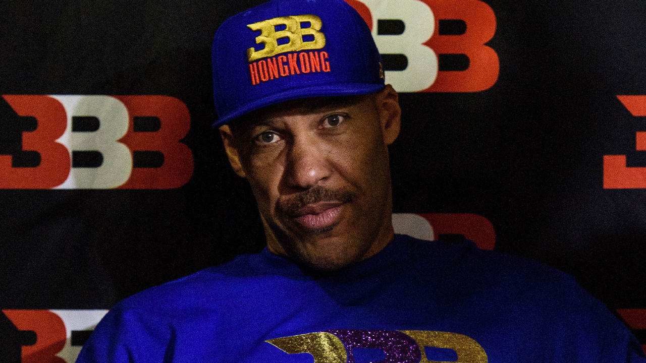 LaVar Ball (L), father of basketball player LiAngelo Ball and the owner of the Big Baller brand, attends a promotional event in Hong Kong on November 14, 2017. UCLA players LiAngelo Ball -- the younger brother of Los Angeles Lakers rookie star Lonzo Ball -- and teammates Cody Riley and Jalen Hill were arrested on November 7 in Hangzhou ahead of their regular-season-opening game against Georgia Tech in nearby Shanghai this past weekend. ESPN reported that they were nabbed on suspicion of stealing from a Louis Vuitton store and later freed on bail but ordered to remain in Hangzhou. / AFP PHOTO / Anthony WALLACE