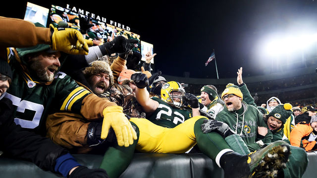 GREEN BAY, WI - JANUARY 8: Aaron Ripkowski #22 of the Green Bay Packers celebrates with fans after scoring a touchdown in the fourth quarter during the NFC Wild Card game against the New York Giants at Lambeau Field on January 8, 2017 in Green Bay, Wisconsin.