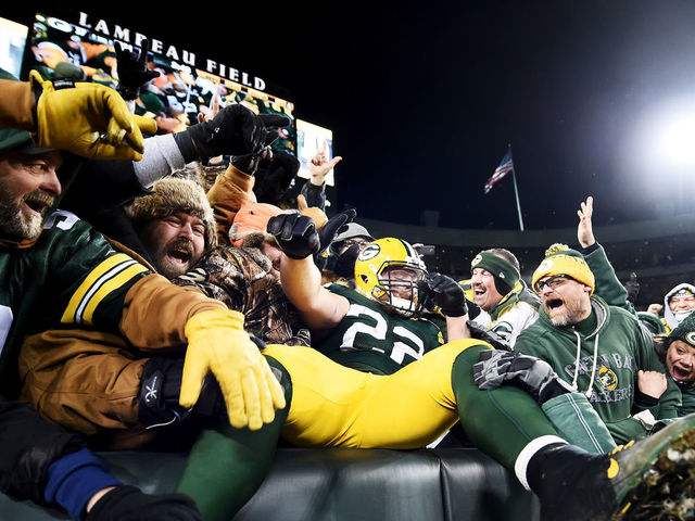 GREEN BAY, WI - JANUARY 8: Aaron Ripkowski #22 of the Green Bay Packers celebrates with fans after scoring a touchdown in the fourth quarter during the NFC Wild Card game against the New York Giants at Lambeau Field on January 8, 2017 in Green Bay, Wisconsin.