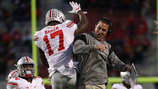 COLLEGE PARK, MD - NOVEMBER 12: Jerome Baker #17 of the Ohio State Buckeyes (L) celebrates with a coach after making a play against the Maryland Terrapins during the second quarter at Capital One Field at Maryland Stadium on November 12, 2016 in College Park, Maryland.