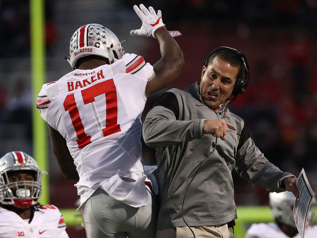 COLLEGE PARK, MD - NOVEMBER 12: Jerome Baker #17 of the Ohio State Buckeyes (L) celebrates with a coach after making a play against the Maryland Terrapins during the second quarter at Capital One Field at Maryland Stadium on November 12, 2016 in College Park, Maryland.