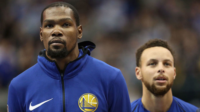 DALLAS, TX - JANUARY 03: (L-R) Kevin Durant #35 of the Golden State Warriors and Stephen Curry #30 of the Golden State Warriors at American Airlines Center on January 3, 2018 in Dallas, Texas.