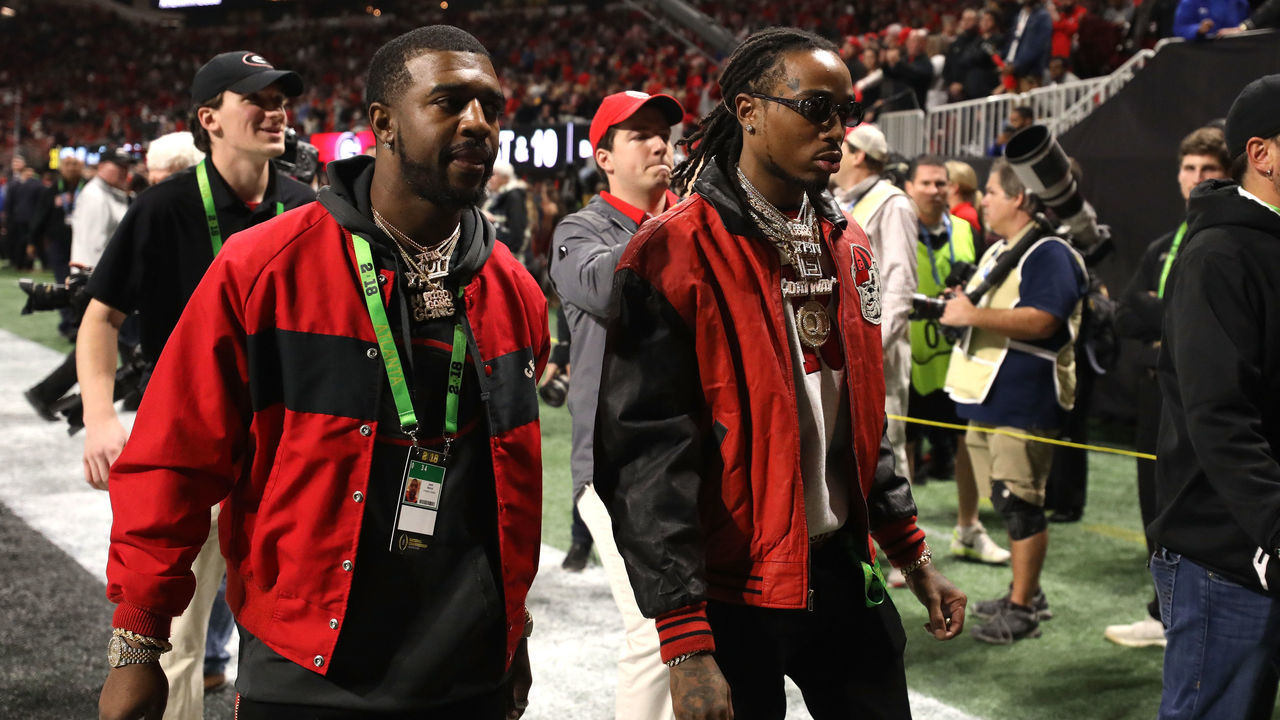 ATLANTA, GA - JANUARY 08: Quavo of Migos walks off the field at the end of the second quarter of the game between the Georgia Bulldogs and the Alabama Crimson Tide in the CFP National Championship presented by AT&T at Mercedes-Benz Stadium on January 8, 2018 in Atlanta, Georgia.