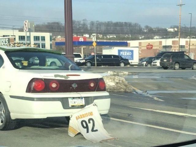 Steelers fan hangs James Harrison jersey off back of car