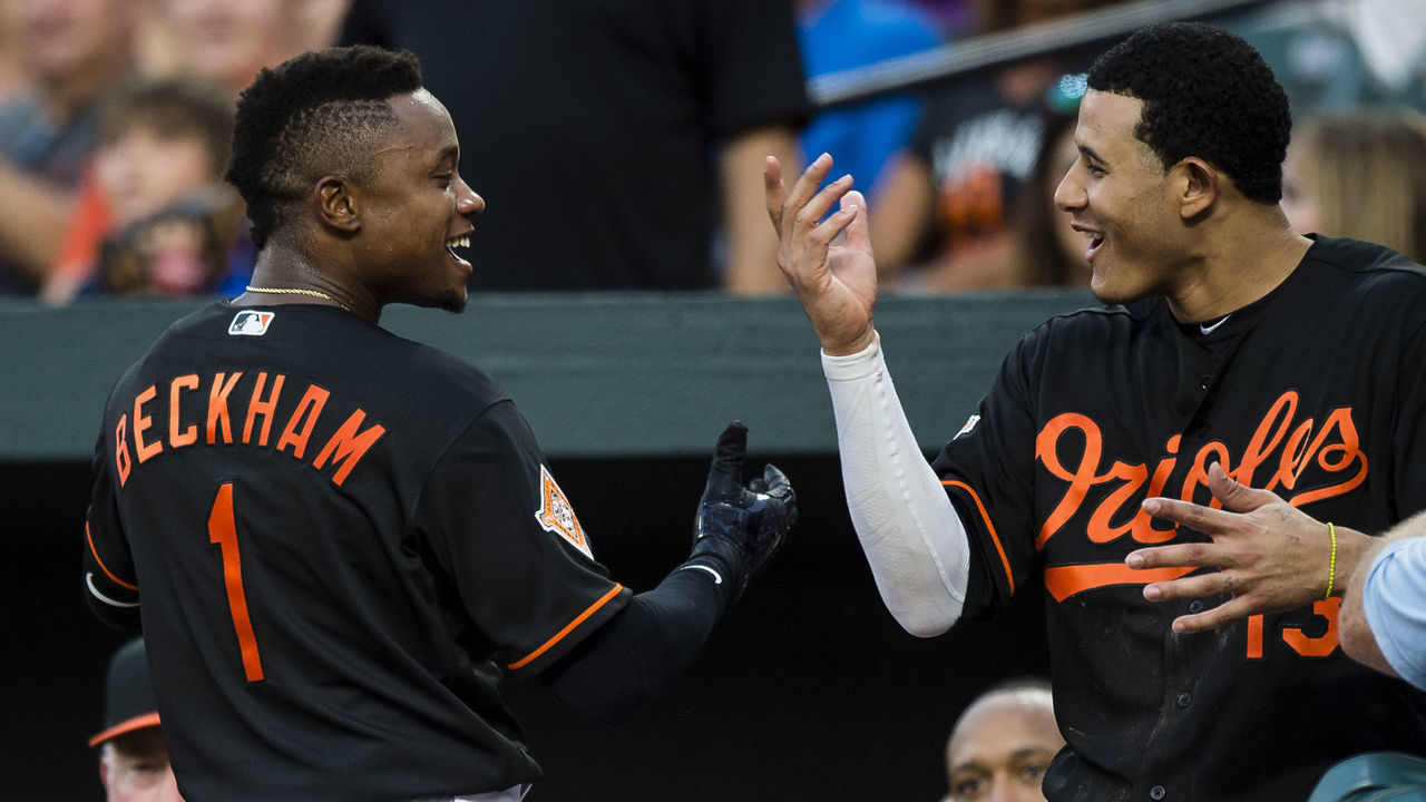 BALTIMORE, MD - AUGUST 04: Tim Beckham #1 of the Baltimore Orioles celebrates with his teammate Manny Machado #13 after hitting a solo home run in the second inning during a game against the Detroit Tigers at Oriole Park at Camden Yards on August 4, 2017 in Baltimore, Maryland.