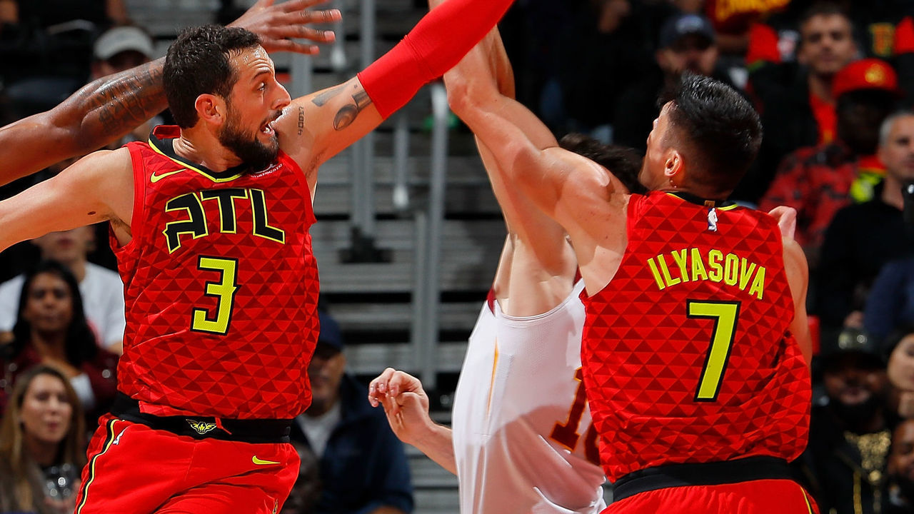 ATLANTA, GA - NOVEMBER 30: Marco Belinelli #3 of the Atlanta Hawks knocks away a rebound against Channing Frye #8 and Cedi Osman #16 of the Cleveland Cavaliers at Philips Arena on November 30, 2017 in Atlanta, Georgia.