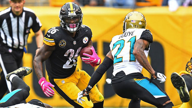 PITTSBURGH, PA - OCTOBER 08: Le'Veon Bell #26 of the Pittsburgh Steelers rushes against Telvin Smith #50 of the Jacksonville Jaguars and A.J. Bouye #21 in the second half during the game at Heinz Field on October 8, 2017 in Pittsburgh, Pennsylvania.