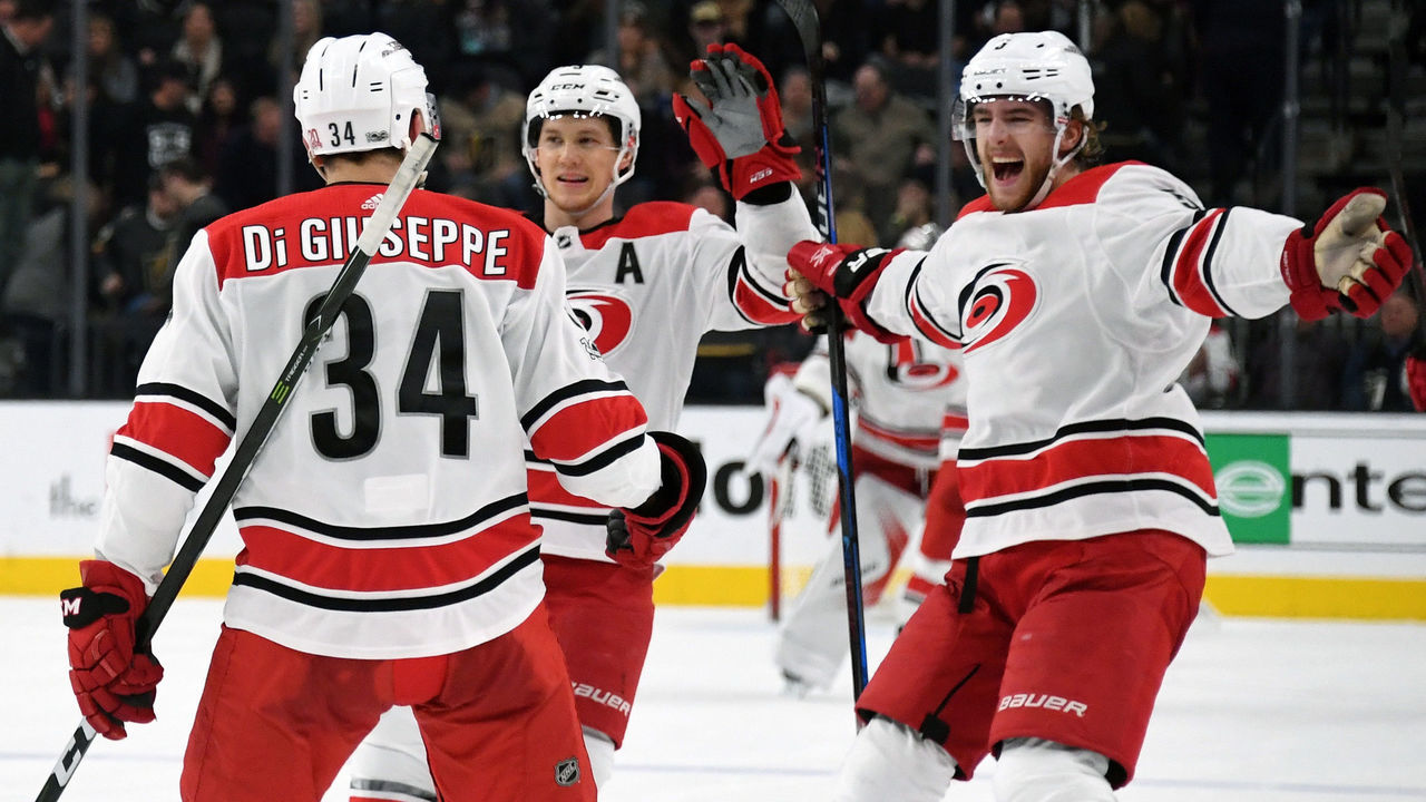 LAS VEGAS, NV - DECEMBER 12: (L-R) Phillip Di Giuseppe #34 of the Carolina Hurricanes celebrates with teammates Jeff Skinner #53 and Noah Hanifin #5 after Di Giuseppe scored against the Vegas Golden Knights in a shootout to win the game 3-2 at T-Mobile Arena on December 12, 2017 in Las Vegas, Nevada.