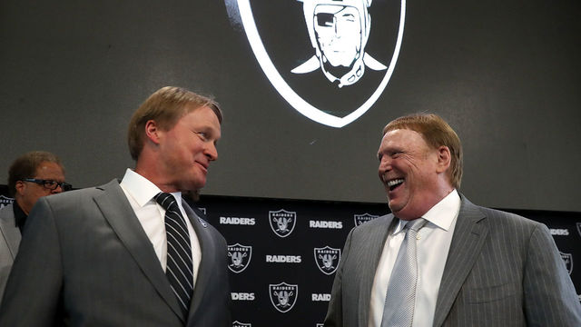 ALAMEDA, CA - JANUARY 09: Oakland Raiders new head coach Jon Gruden (L) talks with Raiders owner Mark Davis during a news conference at Oakland Raiders headquarters on January 9, 2018 in Alameda, California. Jon Gruden has returned to the Oakland Raiders after leaving the team in 2001.