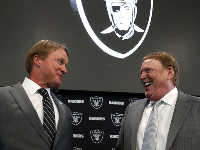 ALAMEDA, CA - JANUARY 09: Oakland Raiders new head coach Jon Gruden (L) talks with Raiders owner Mark Davis during a news conference at Oakland Raiders headquarters on January 9, 2018 in Alameda, California. Jon Gruden has returned to the Oakland Raiders after leaving the team in 2001.