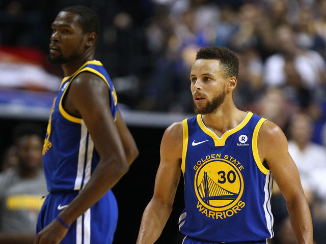 SHANGHAI, CHINA - OCTOBER 08: Stephen Curry #30 and Kevin Durant #35 of the Golden State Warriors look on during the game between the Minnesota Timberwolves and the Golden State Warriors as part of 2017 NBA Global Games China at Mercedes-Benz Arena on October 8, 2017 in Shanghai, China.