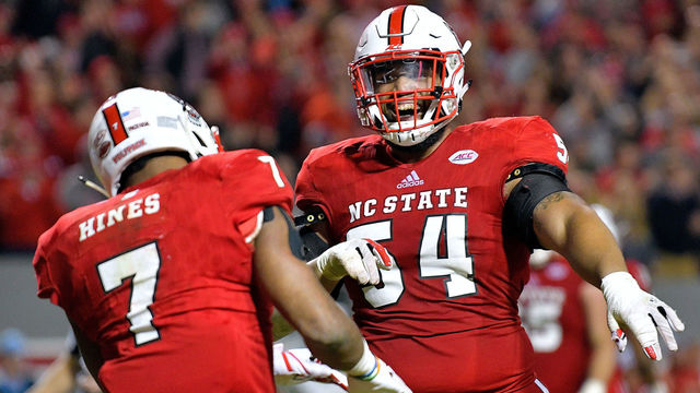 RALEIGH, NC - NOVEMBER 25: Will Richardson #54 of the North Carolina State Wolfpack celebrates with Nyheim Hines #7 of the North Carolina State Wolfpack after Hines' touchdown against the North Carolina Tar Heels during their game at Carter Finley Stadium on November 25, 2017 in Raleigh, North Carolina. North Carolina State won 33-21.