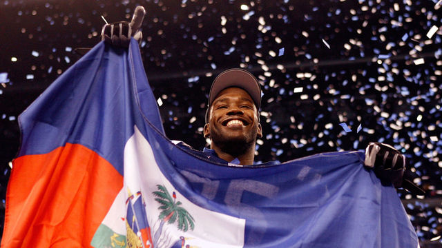 INDIANAPOLIS - JANUARY 24: Wide receiver Pierre Garcon #85 of the Indianapolis Colts celebrates with the Haitian flag after the Colts defeated the New York Jets 30-17 in the AFC Championship Game at Lucas Oil Stadium on January 24, 2010 in Indianapolis, Indiana.