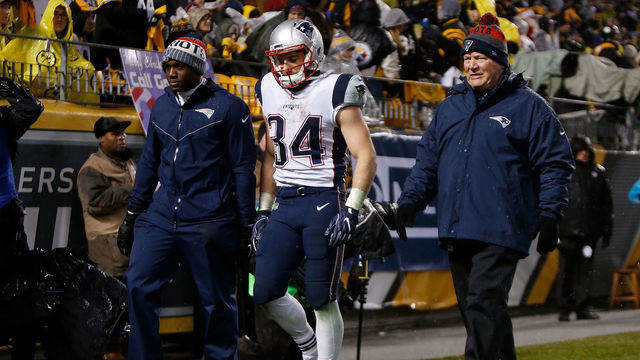 PITTSBURGH, PA - DECEMBER 17: Rex Burkhead #34 of the New England Patriots walks off the field with trainers in the third quarter during the game against the Pittsburgh Steelers at Heinz Field on December 17, 2017 in Pittsburgh, Pennsylvania.