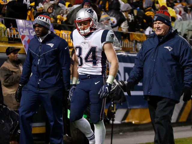 PITTSBURGH, PA - DECEMBER 17: Rex Burkhead #34 of the New England Patriots walks off the field with trainers in the third quarter during the game against the Pittsburgh Steelers at Heinz Field on December 17, 2017 in Pittsburgh, Pennsylvania.