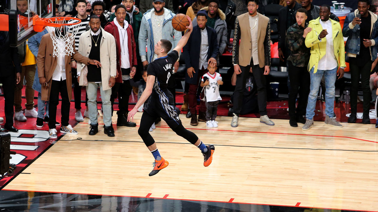 TORONTO, ON - FEBRUARY 13: Zach LaVine of the Minnesota Timberwolves dunks as NBA players look on in the Verizon Slam Dunk Contest during NBA All-Star Weekend 2016 at Air Canada Centre on February 13, 2016 in Toronto, Canada. NOTE TO USER: User expressly acknowledges and agrees that, by downloading and/or using this Photograph, user is consenting to the terms and conditions of the Getty Images License Agreement.