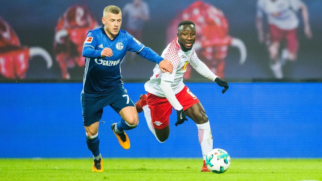 Leipzig's Guinean midfielder Naby Deco Keita (R) and Schalke's midfielder Max Meyer vie for the ball during the German first division Bundesliga football match between RB Leipzig and FC Schalke 04 in Leipzig, eastern Germany, on January 13, 2018. / AFP PHOTO / ROBERT MICHAEL / RESTRICTIONS: DURING MATCH TIME: DFL RULES TO LIMIT THE ONLINE USAGE TO 15 PICTURES PER MATCH AND FORBID IMAGE SEQUENCES TO SIMULATE VIDEO. == RESTRICTED TO EDITORIAL USE == FOR FURTHER QUERIES PLEASE CONTACT DFL DIRECTLY AT + 49 69 650050 / RESTRICTIONS: DURING MATCH TIME: DFL RULES TO LIMIT THE ONLINE USAGE TO 15 PICTURES PER MATCH AND FORBID IMAGE SEQUENCES TO SIMULATE VIDEO. == RESTRICTED TO EDITORIAL USE == FOR FURTHER QUERIES PLEASE CONTACT DFL DIRECTLY AT + 49 69 650050