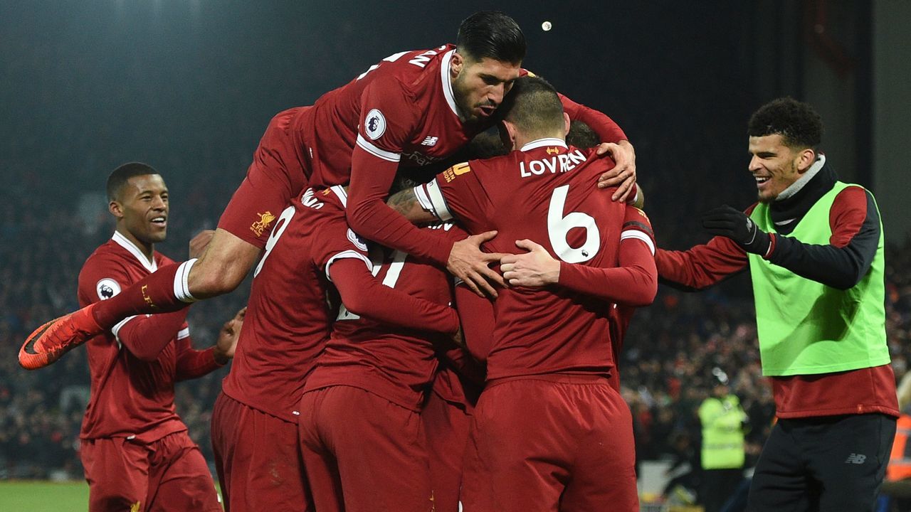 Liverpool's German midfielder Emre Can (L) jumps into the celebration for the third Liverpool goal scored by Liverpool's Senegalese midfielder Sadio Mane during the English Premier League football match between Liverpool and Manchester City at Anfield in Liverpool, north west England on January 14, 2018. / AFP PHOTO / Oli SCARFF /