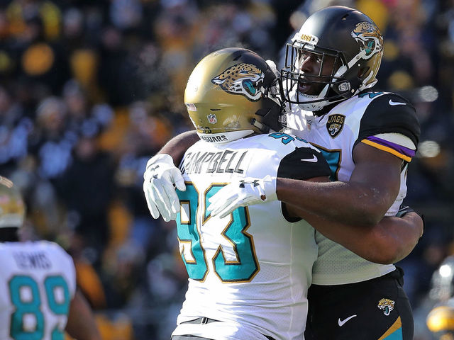 PITTSBURGH, PA - JANUARY 14: Leonard Fournette #27 of the Jacksonville Jaguars celebrates with Calais Campbell #93 after rushing for a 1 yard touchdown in the first quarter during the AFC Divisional Playoff game against the Pittsburgh Steelers at Heinz Field on January 14, 2018 in Pittsburgh, Pennsylvania.