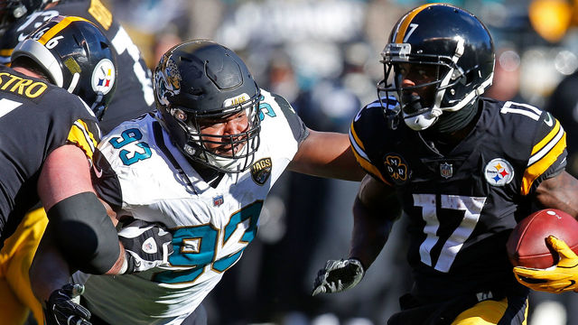 PITTSBURGH, PA - JANUARY 14: Eli Rogers #17 of the Pittsburgh Steelers runs up field against Calais Campbell #93 of the Jacksonville Jaguars after a reception in the first half during the AFC Divisional Playoff game at Heinz Field on January 14, 2018 in Pittsburgh, Pennsylvania.