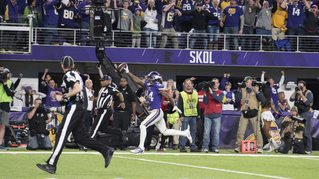 MINNEAPOLIS, MN - JANUARY 14: Stefon Diggs #14 of the Minnesota Vikings runs with the ball to score a touchdown and with as time expired in the NFC Divisional Playoff game against the New Orleans Saints on January 14, 2018 at U.S. Bank Stadium in Minneapolis, Minnesota.