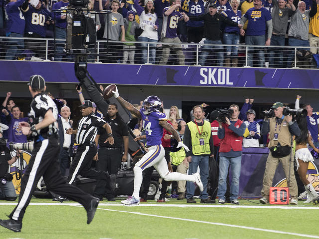 MINNEAPOLIS, MN - JANUARY 14: Stefon Diggs #14 of the Minnesota Vikings runs with the ball to score a touchdown and with as time expired in the NFC Divisional Playoff game against the New Orleans Saints on January 14, 2018 at U.S. Bank Stadium in Minneapolis, Minnesota.