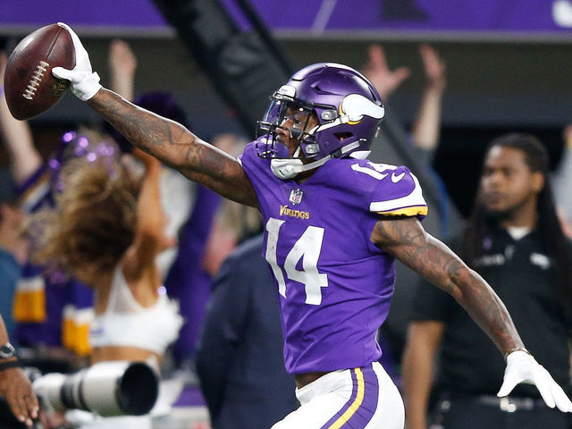 MINNEAPOLIS, MN - JANUARY 14: Stefon Diggs #14 of the Minnesota Vikings scores a touchdown as time expires against the New Orleans Saints during the second half of the NFC Divisional Playoff game at U.S. Bank Stadium on January 14, 2018 in Minneapolis, Minnesota.