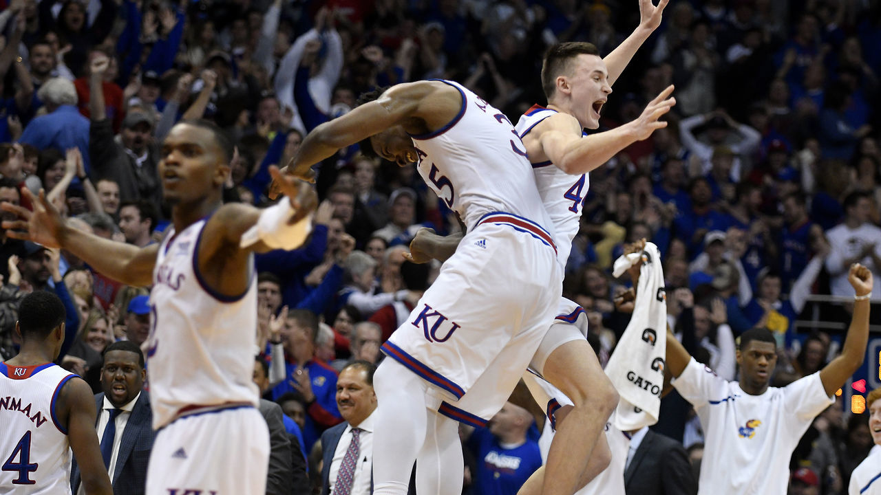 LAWRENCE, KS - JANUARY 13: Udoka Azubuike #35 and Mitch Lightfoot #44 of the Kansas Jayhawks celebrate a 73-72 win over the Kansas State Wildcats at Allen Fieldhouse on January 13, 2018 in Lawrence, Kansas.