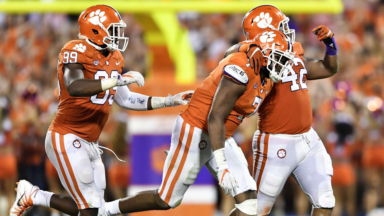 CLEMSON, SC - SEPTEMBER 09: Defensive end Austin Bryant #7, defensive end Clelin Ferrell #99, and defensive lineman Christian Wilkins #42 of the Clemson Tigers celebrate following a sack made by Bryant against the Auburn Tigers at Memorial Stadium on September 9, 2017 in Clemson, South Carolina.