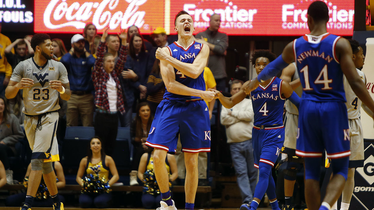 MORGANTOWN, WV - JANUARY 15: Mitch Lightfoot #44 of the Kansas Jayhawks reacts after dunking on Sagaba Konate #50 of the West Virginia Mountaineers (not pictured) putting Kansas up 69-66 at the WVU Coliseum on January 15, 2018 in Morgantown, West Virginia.