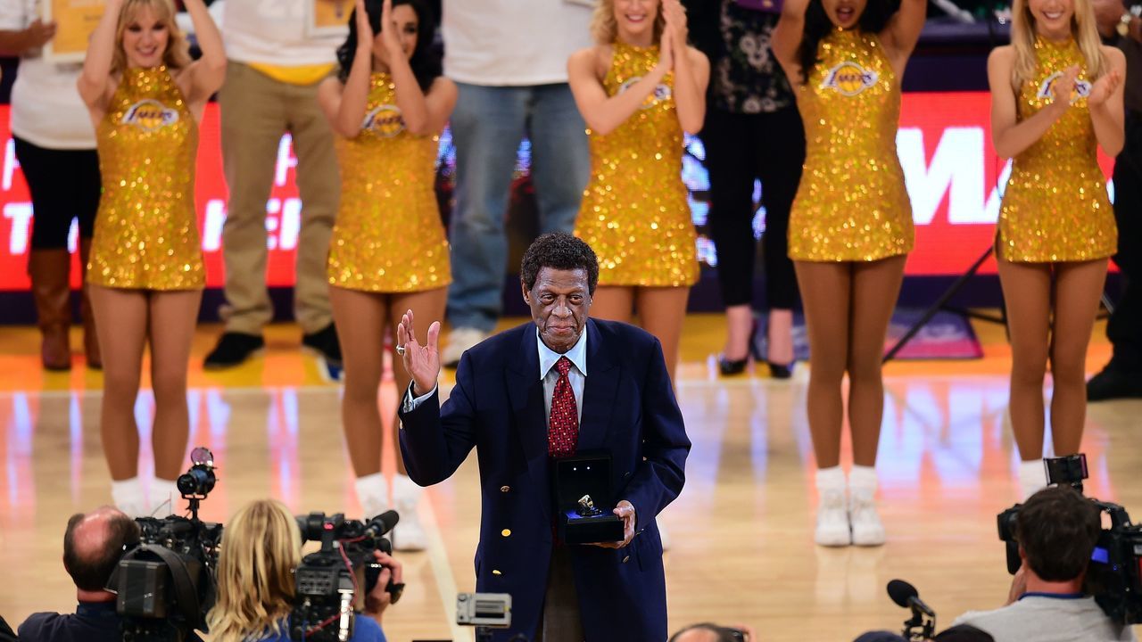 NBA legend and former Laker Elgin Baylor acknowledges the crowd upon reception of an award at halftime during the Los Angeles Lakers v Golden State Warriors NBA game at Staples Center in Los Angeles, California on November 16, 2014, where the Warriors defeated the Lakers 136-115. AFP PHOTO/Frederic J. BROWN