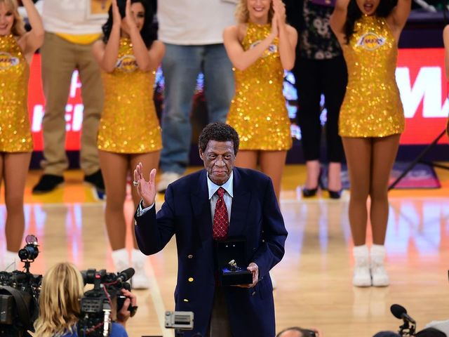 NBA legend and former Laker Elgin Baylor acknowledges the crowd upon reception of an award at halftime during the Los Angeles Lakers v Golden State Warriors NBA game at Staples Center in Los Angeles, California on November 16, 2014, where the Warriors defeated the Lakers 136-115. AFP PHOTO/Frederic J. BROWN