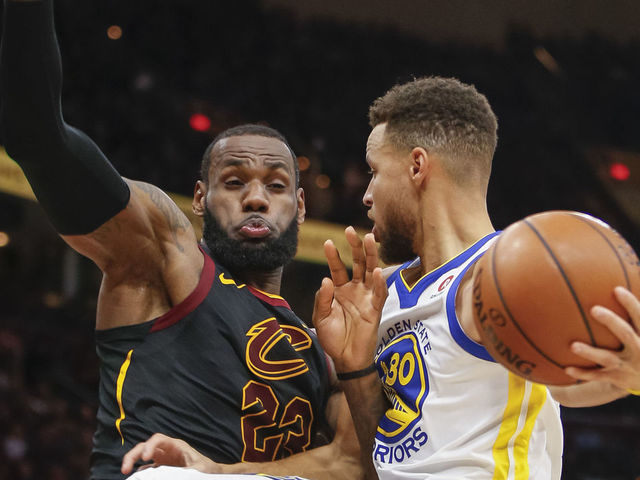 CLEVELAND, OH - JANUARY 15: Stephen Curry #30 of the Golden State Warriors collides with LeBron James #23 of the Cleveland Cavaliers while driving to the basket at Quicken Loans Arena on January 15, 2018 in Cleveland, Ohio.