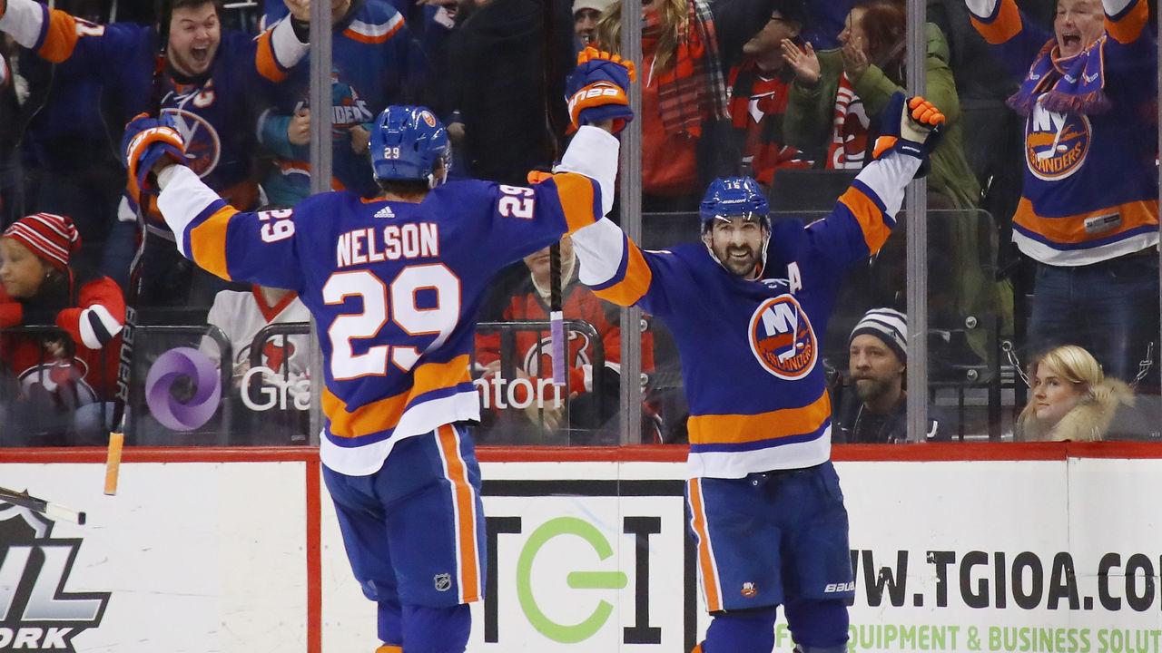 NEW YORK, NY - JANUARY 07: Cal Clutterbuck #15 of the New York Islanders (r) celebrates his game tying goal at 15:53 of the third period against the New Jersey Devils and is joined by Brock Nelson #29 (l) at the Barclays Center on January 7, 2018 in the Brooklyn borough of New York City.