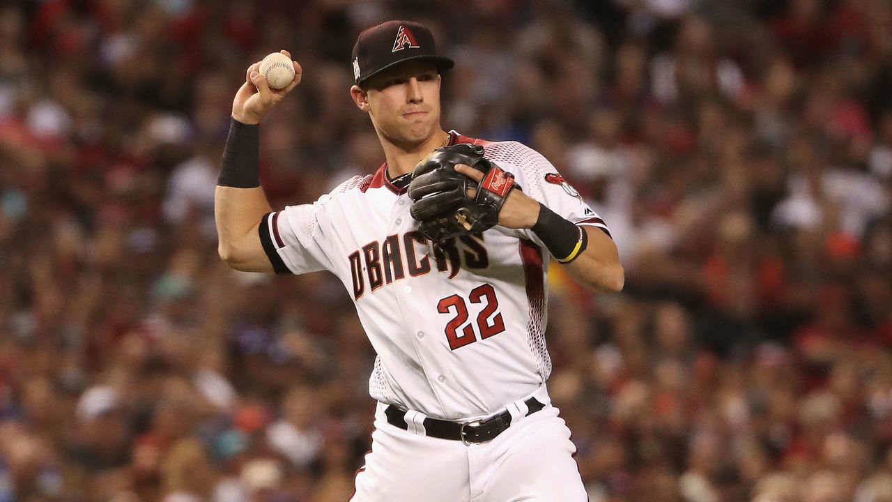 PHOENIX, AZ - OCTOBER 09: Jake Lamb #22 of the Arizona Diamondbacks fields a ground ball out during the sixth inning of the National League Divisional Series game three against the Los Angeles Dodgers at Chase Field on October 9, 2017 in Phoenix, Arizona.