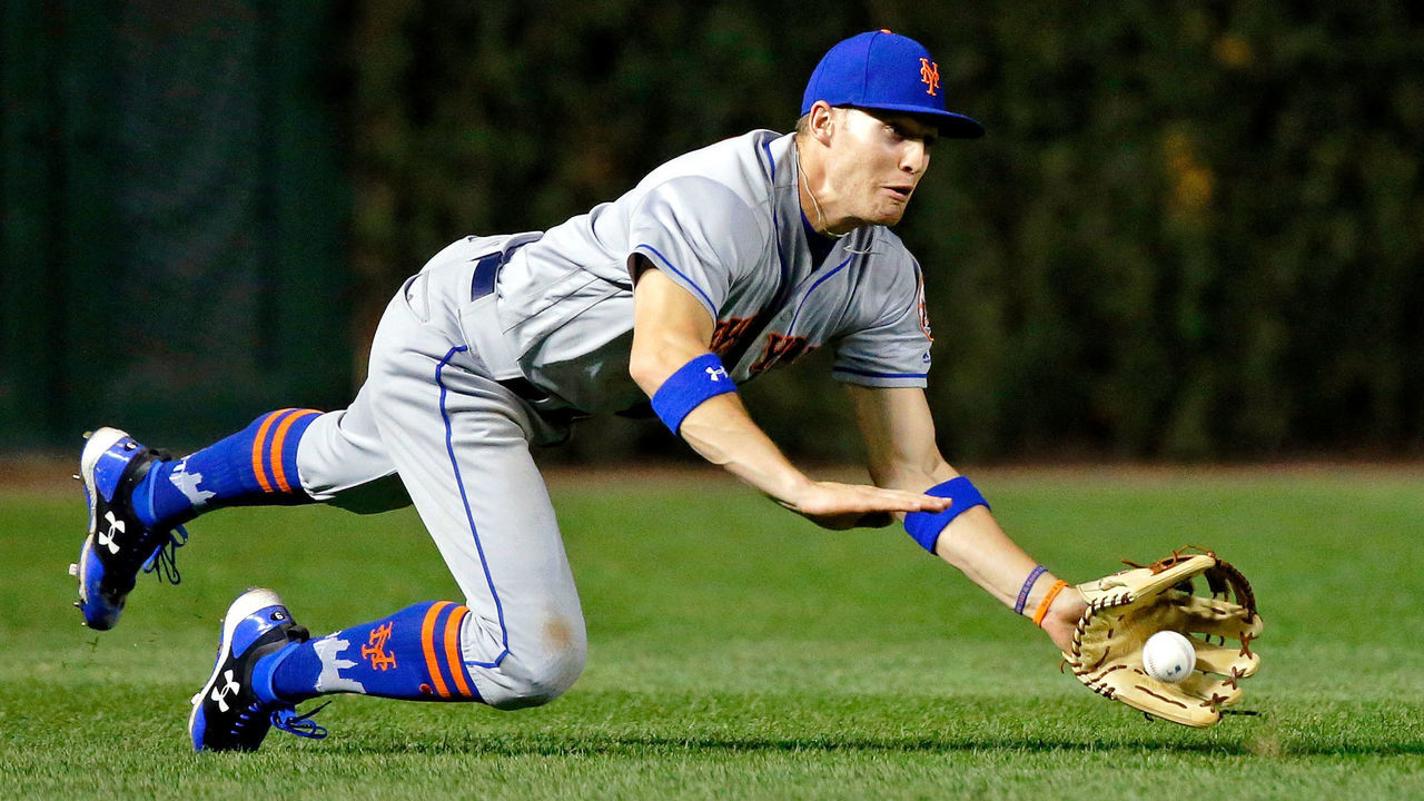 CHICAGO, IL - SEPTEMBER 14: Brandon Nimmo #9 of the New York Mets fields a ball after bouncing in the grass off a hit by Jon Jay #30 of the Chicago Cubs (not pictured) during the sixth inning at Wrigley Field on September 14, 2017 in Chicago, Illinois.