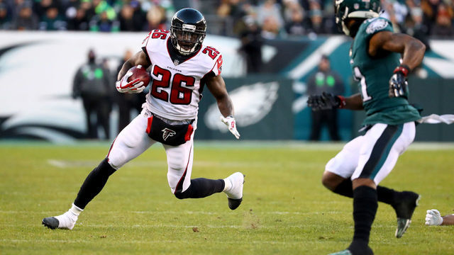 PHILADELPHIA, PA - JANUARY 13: Running back Tevin Coleman #26 of the Atlanta Falcons runs the ball against cornerback Jalen Mills #31 of the Philadelphia Eagles during the first quarter in the NFC Divisional Playoff game at Lincoln Financial Field on January 13, 2018 in Philadelphia, Pennsylvania.