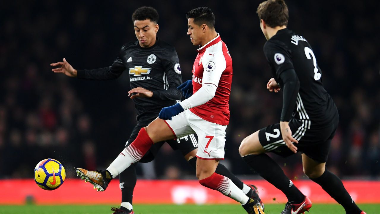 LONDON, ENGLAND - DECEMBER 02: Alexis Sanchez of Arsenal is challenged by Jesse Lingard of Manchester United during the Premier League match between Arsenal and Manchester United at Emirates Stadium on December 2, 2017 in London, England.