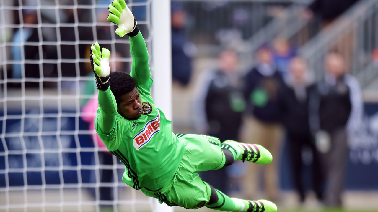 CHESTER, PA - MARCH 20: Goalkeeper Andre Blake #1 of Philadelphia Union dives to make a save as the ball get past him and bounces off the post against the New England Revolution at Talen Energy Stadium on March 20, 2016 in Chester, Pennsylvania.