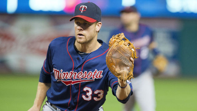 CLEVELAND, OH - AUGUST 24: Justin Morneau #33 of the Minnesota Twins fields a ground ball hit by Michael Bourn #24 of the Cleveland Indians to end the sixth inning at Progressive Field on August 24, 2013 in Cleveland, Ohio.