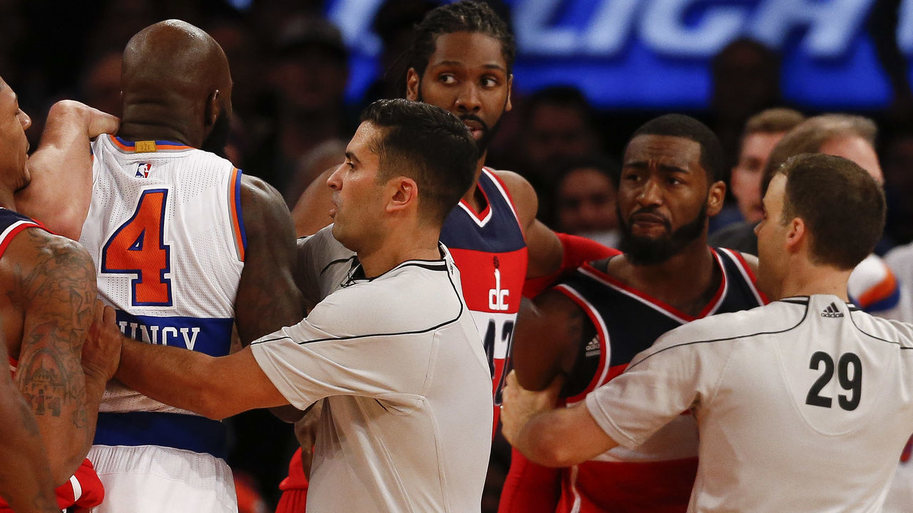 NEW YORK, NY - DECEMBER 25: Officials break up a scuffle between Quincy Acy #4 of the New York Knicks and John Wall #2 of the Washington Wizards in the second half of their game at Madison Square Garden on December 25, 2014 in New York City. NOTE TO USER: User expressly acknowledges and agrees that, by downloading and/or using this photograph, user is consenting to the terms and conditions of the Getty Images License Agreement.