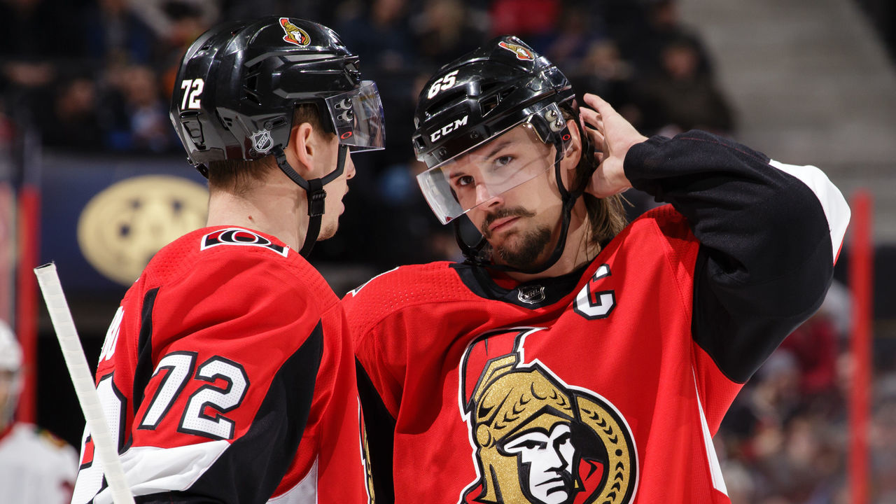 OTTAWA, ON - JANUARY 9: Teammates Thomas Chabot #72 and Erik Karlsson #65 of the Ottawa Senators chat during a stoppage in play in a game against the Chicago Blackhawks at Canadian Tire Centre on January 9, 2018 in Ottawa, Ontario, Canada.