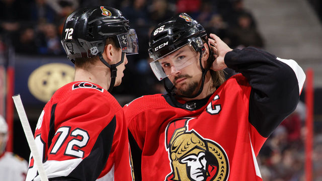 OTTAWA, ON - JANUARY 9: Teammates Thomas Chabot #72 and Erik Karlsson #65 of the Ottawa Senators chat during a stoppage in play in a game against the Chicago Blackhawks at Canadian Tire Centre on January 9, 2018 in Ottawa, Ontario, Canada.