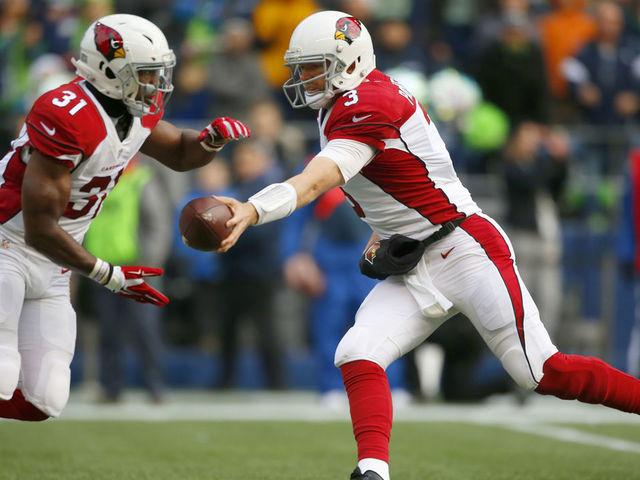 SEATTLE, WA - DECEMBER 24: Quarterback Carson Palmer #3 of the Arizona Cardinals hands off to running back David Johnson #31 against the Seattle Seahawks at CenturyLink Field on December 24, 2016 in Seattle,Washington.