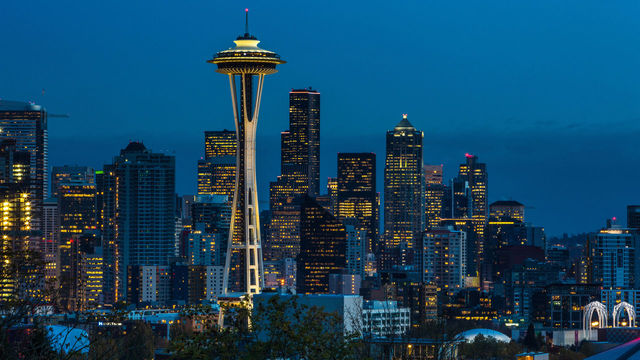 SEATTLE, WA - NOVEMBER 4: The sun sets on the Space Needle and downtown skyline as viewed at dusk on November 4, 2015, in Seattle, Washington. Seattle, located in King County, is the largest city in the Pacific Northwest, and is experiencing an economic boom as a result of its European and Asian global business connections.