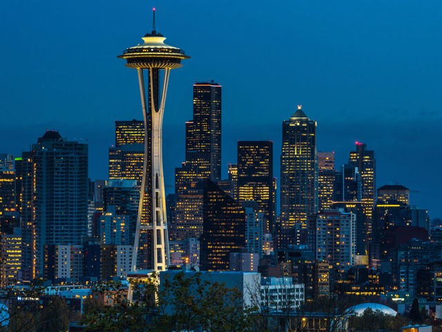 SEATTLE, WA - NOVEMBER 4: The sun sets on the Space Needle and downtown skyline as viewed at dusk on November 4, 2015, in Seattle, Washington. Seattle, located in King County, is the largest city in the Pacific Northwest, and is experiencing an economic boom as a result of its European and Asian global business connections.