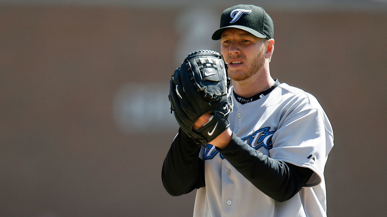 DETROIT - APRIL 02: Starting pitcher Roy Halladay #34 of the Toronto Blue Jays looks towards the catcher for a sign as he gets set to throw a pitch against the Detroit Tigers during the Home Opener for the Detroit Tigers at Comerica Park on April 2, 2007 in Detroit, Michigan