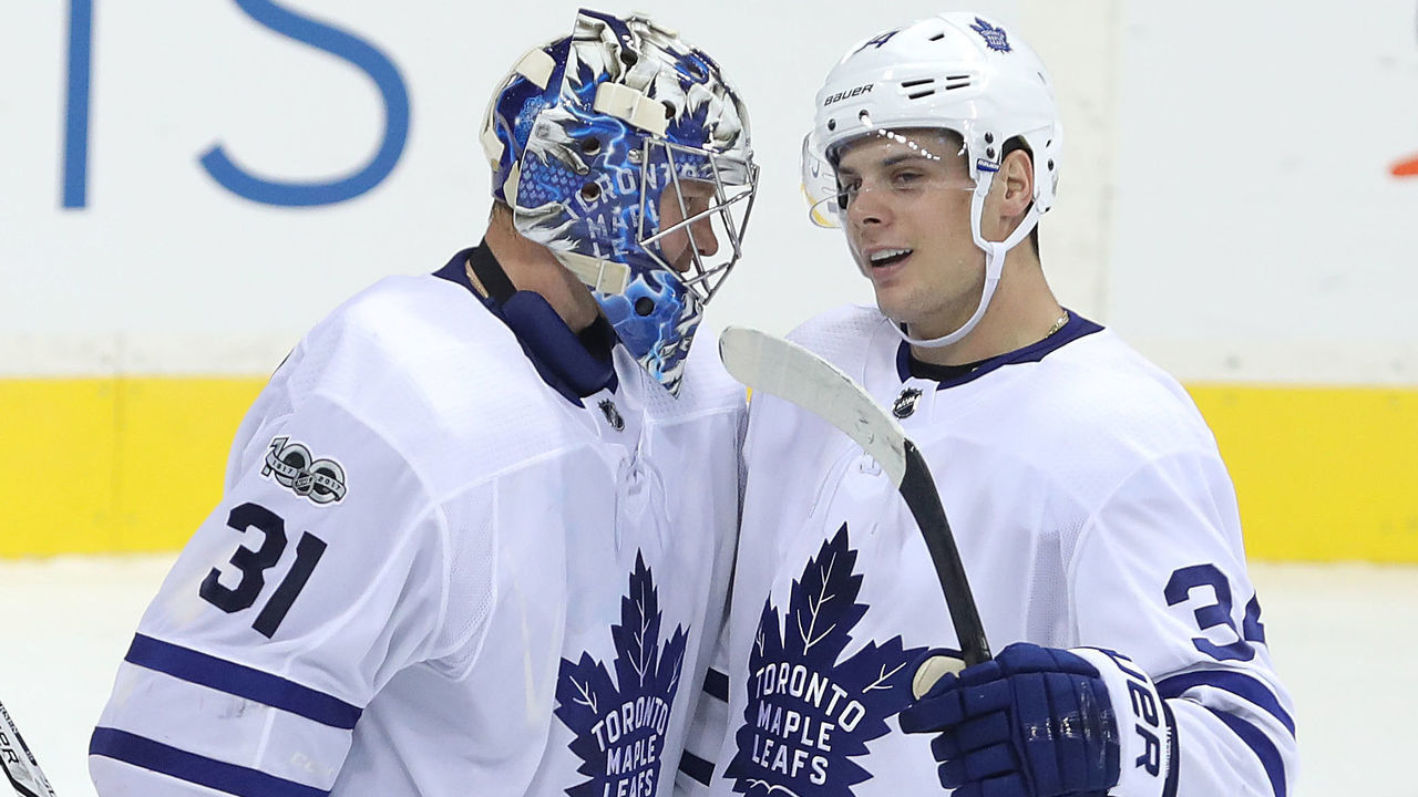 WINNIPEG, MANITOBA - OCTOBER 4: Forward Auston Matthews #34 of the Toronto Maple Leafs congratulates goaltender Frederik Andersen #31 after defeating the Winnipeg Jets during NHL action on October 4, 2017 at the Bell MTS Place in Winnipeg, Manitoba.